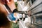 worker using electrical cord screwdriver for fastening screws into metal fence