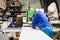 Worker using filler machine to make furniture at carpenters work