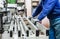 Worker using filler machine to make furniture at carpenters work