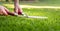 A worker is using a hedge trimmer to cut the grass