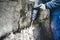 Worker using a jackhammer to drill into wall. professional worker in construction site