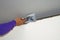 Worker using plaster gypsum on putty knife at ceiling