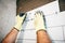 Worker using plastic distancer for adjusting ceramic tiles on bathroom walls