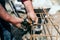 Worker using steel wire and pincers to secure steel bars, preparing for concrete pouring on industrial construction site