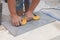 Worker using suction plate for tile installation indoors, closeup