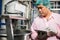 Worker using tablet in beverage factory oversees soda water filling