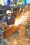 Worker using torch cutter to cut through metal