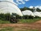 Worker using a tractor to spray raspberry plants at christmas hills farm in tasmania