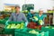 Worker of vegetable sorting factory arranging boxes with lettuce