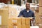 Worker In Warehouse Preparing Goods For Dispatch