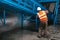 The worker washes the equipment at the waste sorting plant. Waste processing plant. Technological process. Recycling and