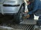 Worker washes sponge wheel of the car