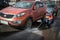 A worker washes the street in places where cars are parked