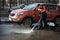 A worker washes the street in places where cars are parked