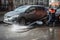 A worker washes the street in places where cars are parked