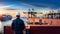 a worker watching a busy port full with containers and ship