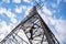 A worker wearing safety suits climb up high-voltage pylons to maintain high-voltage power stations