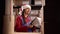 Worker wearing Santa claus hat checking a products on shelf in warehouse storage uses clipboard