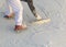 Worker Wearing Spiked Shoes Smoothing Wet Pool Plaster With Trowel