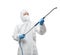 Worker wears medical protective suit or white coverall suit with equipment for spray