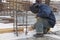 Worker welding a metal lattice at