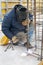 Worker welding a metal lattice at