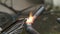 Worker welds pipe gas welding. Closeup. sparks flying around flame. fuel gases and oxygen to weld  metals. Slow Motion 120fps