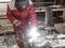 Worker welds a reinforcement metal frame