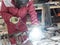 Worker welds a reinforcement metal frame