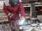 Worker welds a reinforcement metal frame