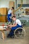 Worker in wheelchair in a carpenter\'s workshop