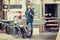 Worker in wheelchair in a carpenter`s workshop with his colleagu