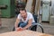 Worker in wheelchairworkong in a carpenter`s workshop