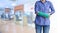 worker woman accident on arm with green arm cast on blurred business office working space background