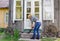 Worker woman clean sweep stairs with wooden broom