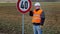 Worker working with adjustable wrench near road sign