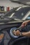 Worker working on a car with electric buffer