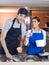 Worker Working With Coworker At Counter In Ice Cream Parlor