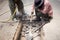 Worker working on the road demolishing asphalt with pneumatic pl