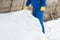 A worker in a workwear is covering with a special cloth the bottom of an artificial lake, close-up