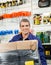 Worker With Wrapped Package In Hardware Shop