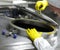 Worker in yellow gloves opening industrial process tank