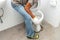 workerman performs repair of toilet bowl,