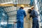 Workers applying insulation material to an industrial boiler