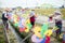 Workers assemble flower shaped plastic windmill near roadside