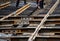 Workers assemble wooden sleepers and tram rails during the repair of city roads.