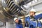 Workers assembling and constructing gas turbines in a modern ind