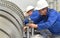 Workers assembling and quality control of gas turbines in a mode