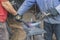 Workers bend a red-hot metal plate