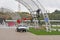 Workers in a bucket of a truck crane install LED lighting on an arch in Victory Park